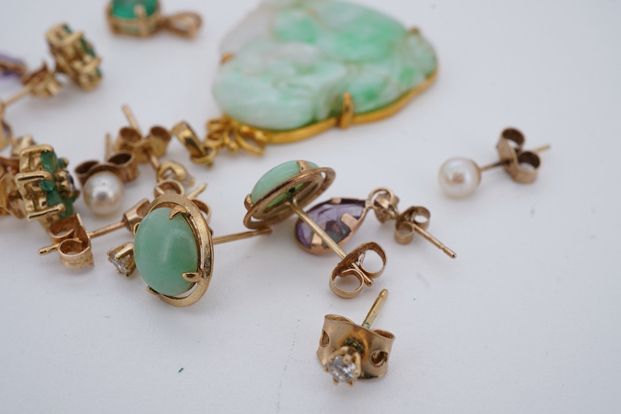 A collection of earrings and two pendants, comprising: two pairs and one single diamond studs, each set with a brilliant-cut diamond weighing approximately 0.07 carats; a pair of emerald and diamond cluster stud earrings